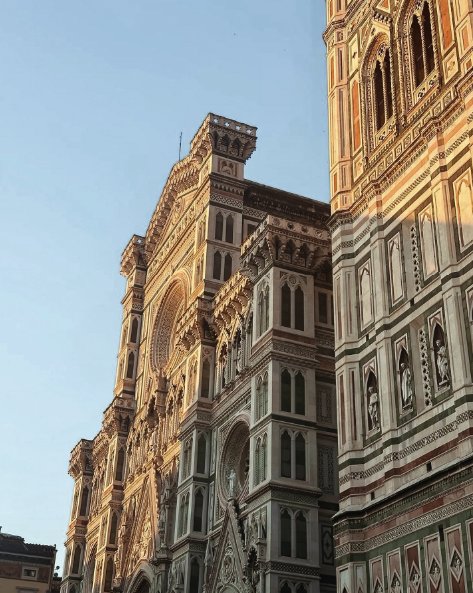 The Gothic marble facade and campanile of the Florence Duomo in golden light
