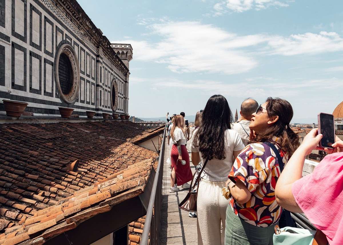Visitors on the hidden terraces of the Florence Duomo looking over the city